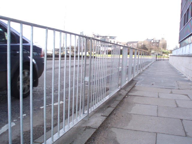 Pedestrian barrier with staggered infill and posts to proving better through vision.