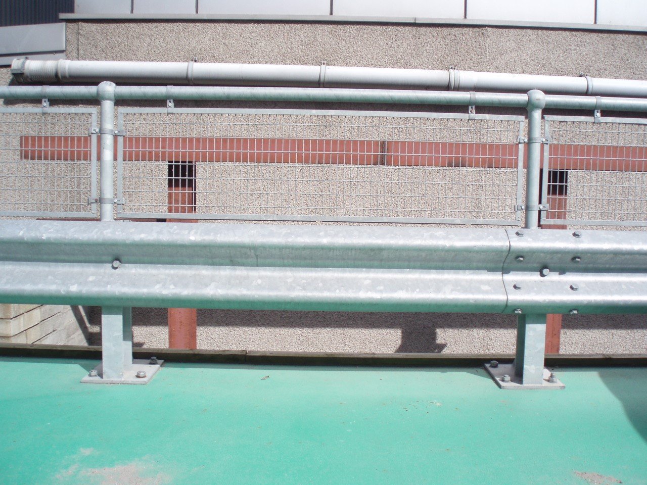 Infilled handrail above corugated beam barrier.